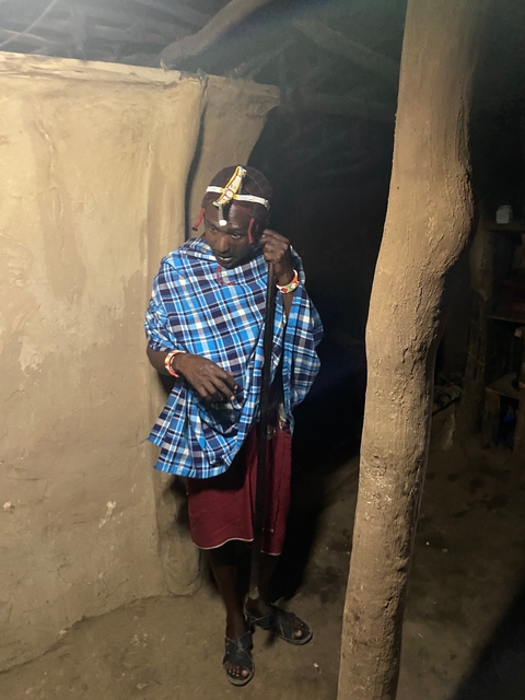       Person in traditional attire standing indoors.
  