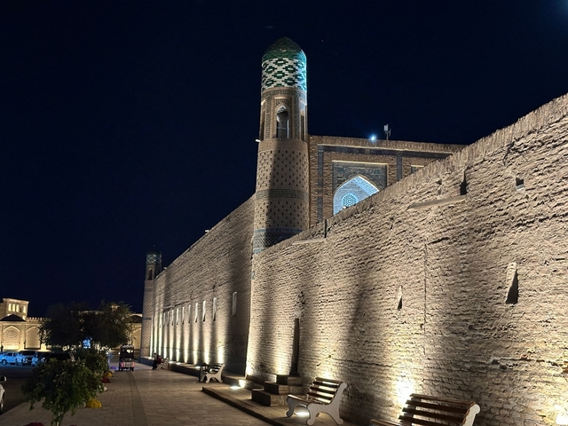 Illuminated historic architecture with towers at night.