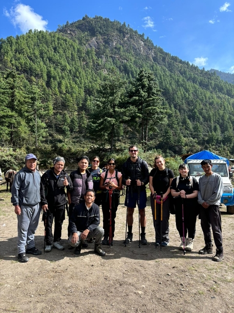 Two people in traditional and casual clothing indoors.