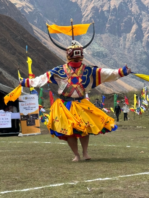 Man in traditional attire performing a cultural dance.