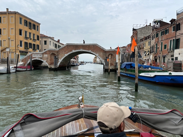 View of a bridge over a canal with boats.