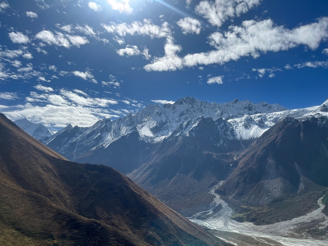 Majestic view of snow-capped mountains under a clear blue sky.