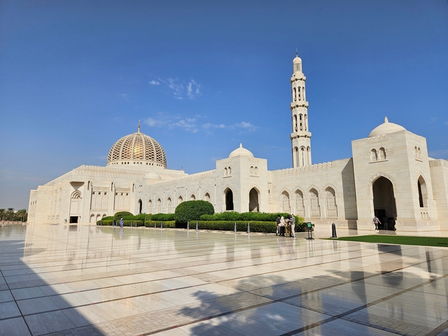 Grand Mosque with ornate architecture and blue sky.