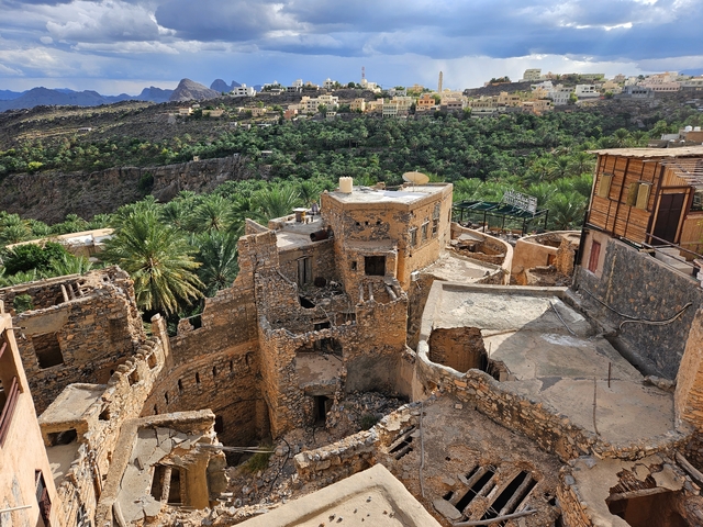 Ruins of a stone settlement in a mountainous area.
