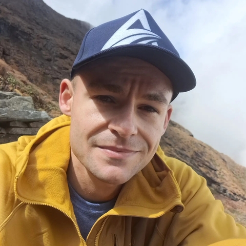       Close-up of a person wearing a cap and a jacket.
  