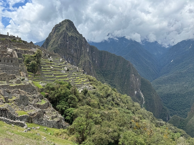       View of Machu Picchu and surrounding mountains.
  