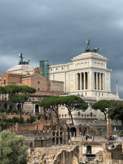       Historic monument with statues and cloudy sky
  