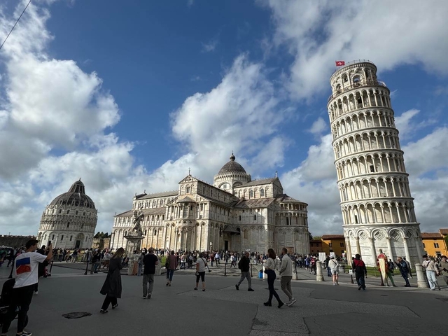       Leaning Tower of Pisa with a lively square and buildings
  
