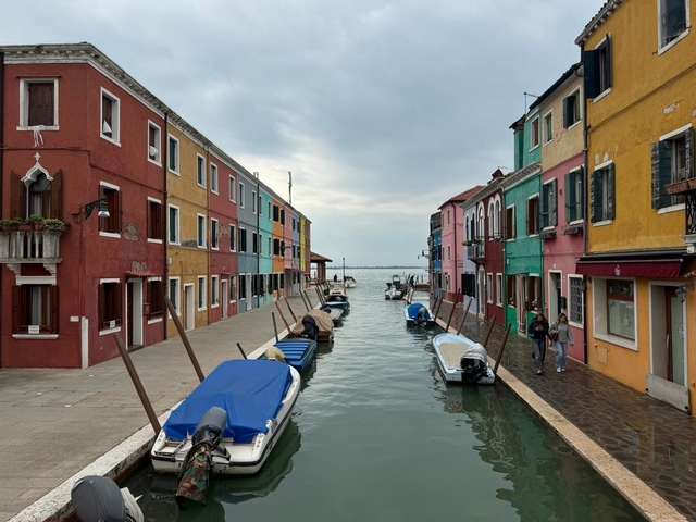       Colorful buildings with moored boats on an island canal
  