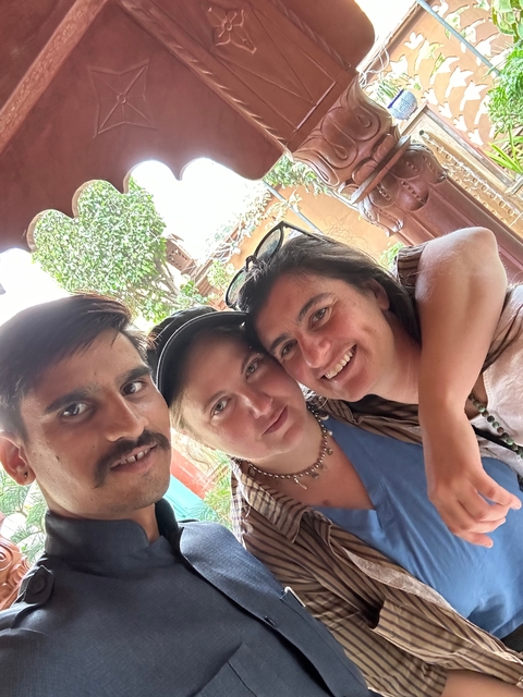 Three people smiling in an outdoor setting.