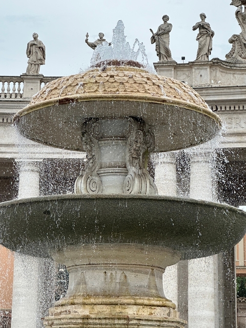       Fountain with flowing water in front of a building.
  