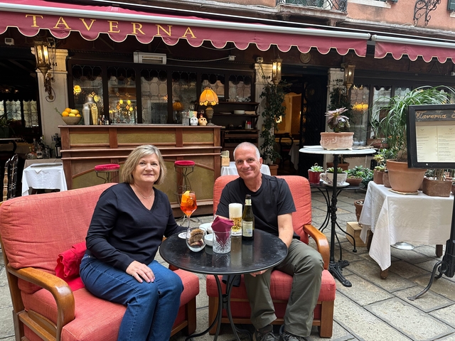 Two people enjoying drinks at a cozy cafe.