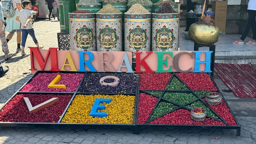       Colorful display of spices with Marrakech signage.
  