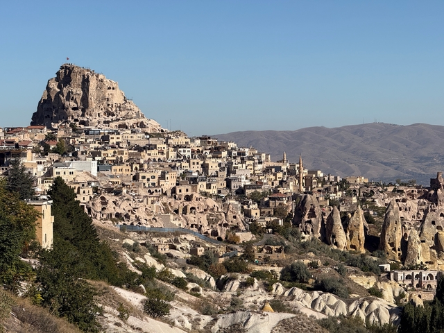       A town built into a rocky hillside.
  
