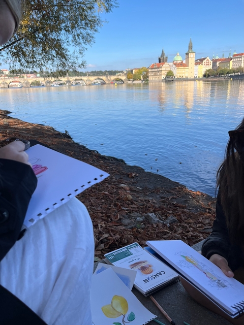 Person sketching near a water body.