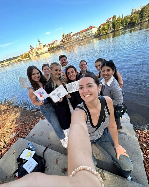 Group of friends posing by a river.