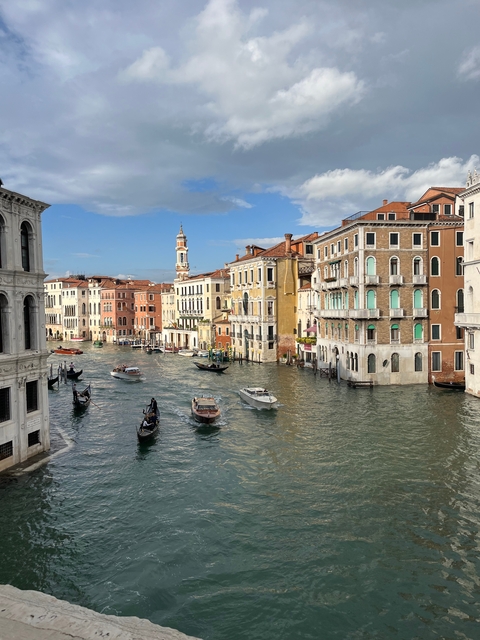 Scenic view of Venice canals with gondolas and buildings.