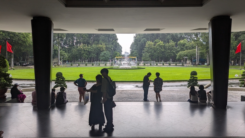 View out from a building entrance to a garden area with a fountain.