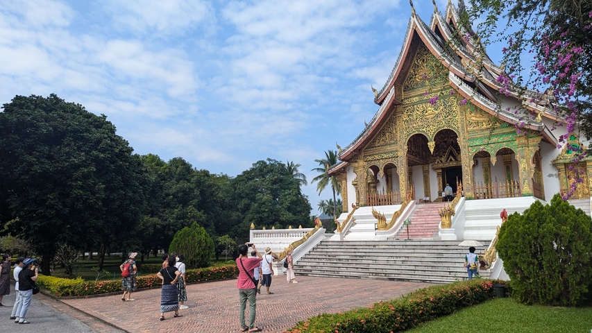 Beautiful temple with intricate architecture and people visiting.
