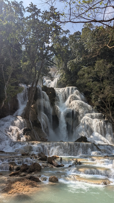       Picturesque waterfall cascading down rocky terrain.
  