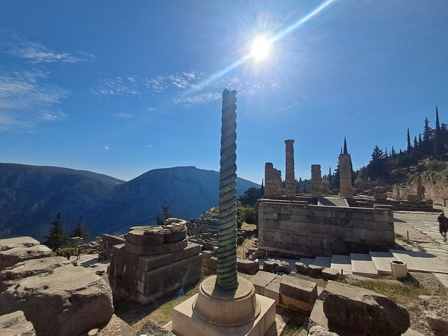 Ancient ruins in mountainous landscape with clear sky.