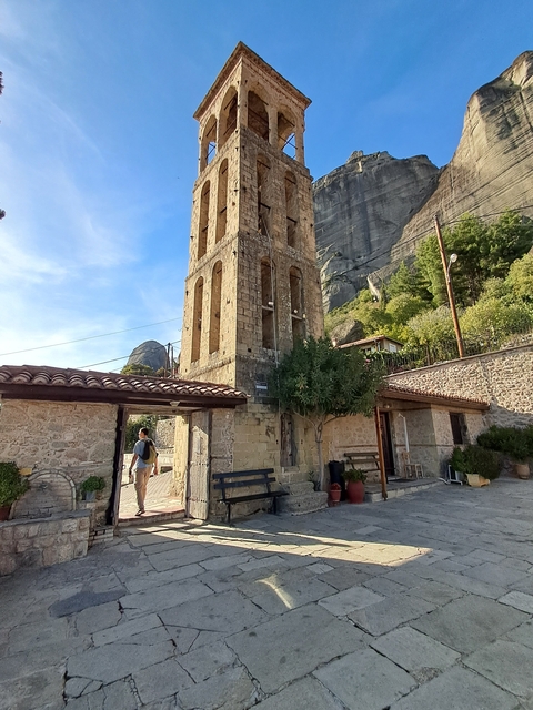 Stone building with a mountainous backdrop.