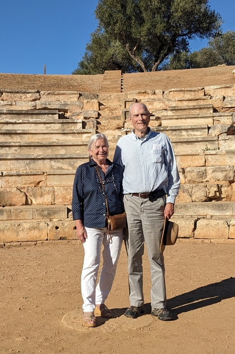 Couple posing in front of ancient stone steps.
