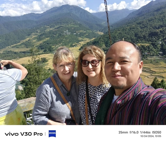       Three people taking a selfie with a valley in the background
  