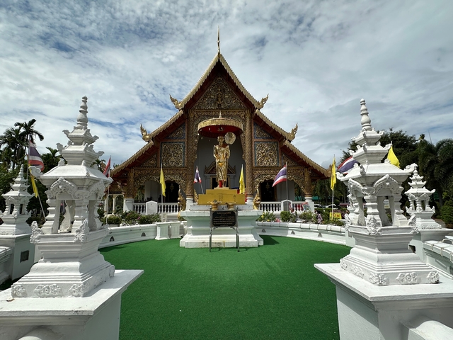       Intricate temple facade with statues and flags.
  