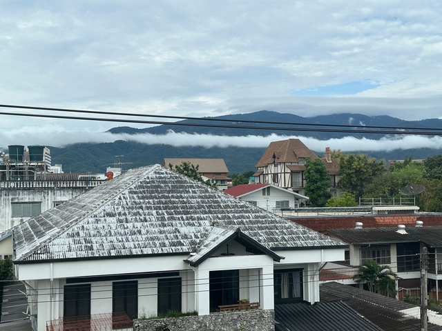       Rooftop view with mountains in the background.
  