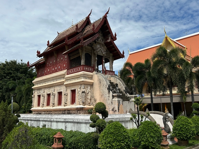      Historic building surrounded by trees and garden.
  