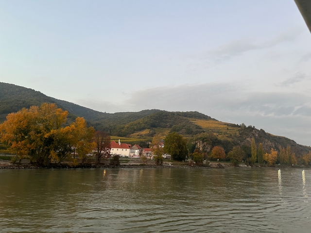       River scene with hills and autumn foliage.
  