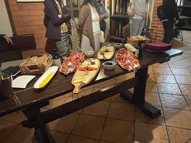 Assorted cold cuts and cheese on a wooden table indoors.