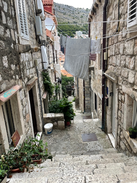 Narrow stone alleyway in a historic city.