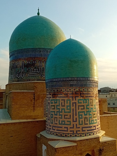       Intricately tiled domes of an Islamic structure.
  