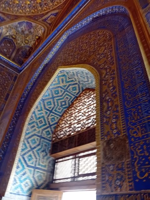      Interior shot of a building with blue mosaic tiles.
  