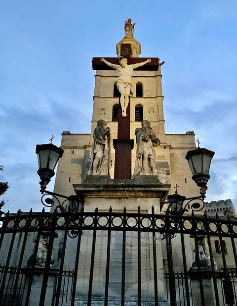       Statues of religious figures on a building facade.
  