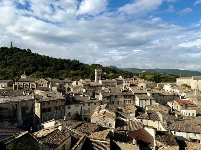       Aerial view of an old town with a mountainous backdrop.
  