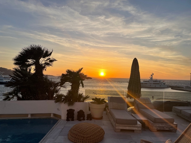 Sunset view overlooking a marina with yachts.