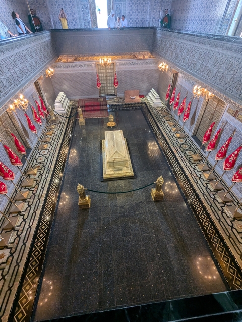       An interior view of a mausoleum with flags.
  