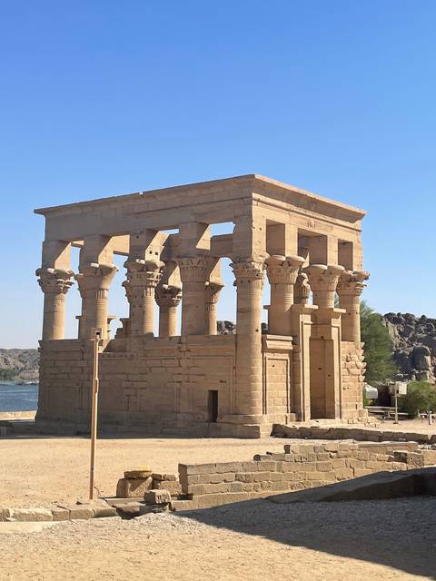 The Temple of Philae by the water with historical columns.