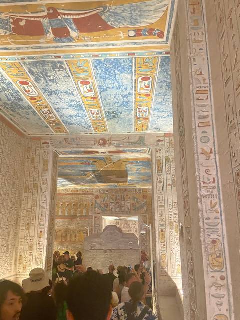 Interior view of an ancient Egyptian tomb with colorful hieroglyphics.