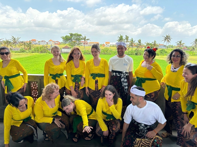       Group of people in traditional costumes in fields.
  