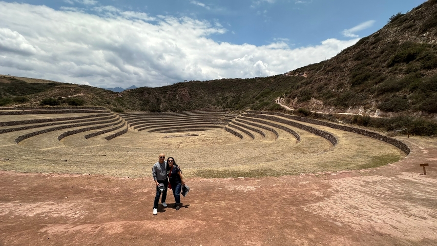       Couple standing in front of Moray archaeological site.
  