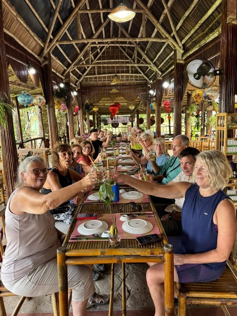       Group of people at a long dining table indoors
  