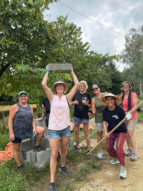       Women outdoors with a stone, participating in an activity
  