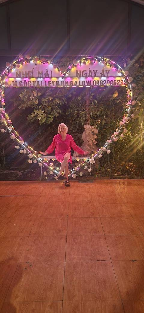       Woman posing on a decorative swing with lights
  