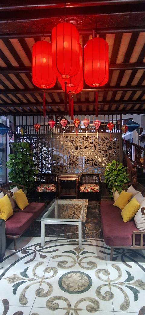 Beautiful interior with traditional wooden carvings and colorful lanterns.