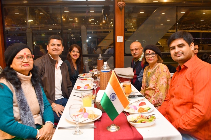 Group dining together with flags and decorations on the table.