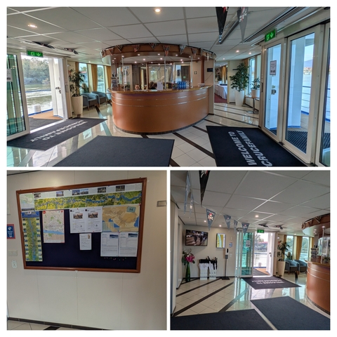       Interior of ship with information boards and reception.
  